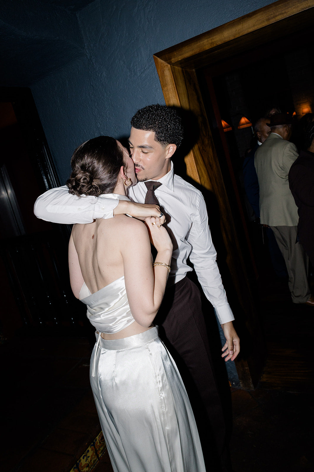 Bride Gracie in a custom ivory silk halter top designed with a cowl drape style and wide-leg trousers by Harleen Kaur