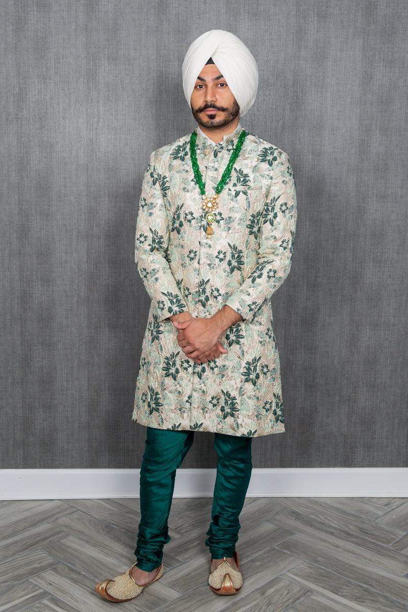 front-facing man wearing the JEEVAT mint and green sherwani with evergreen pajama pants and a white turban
