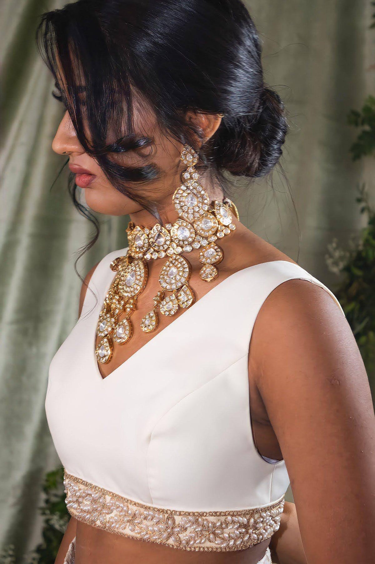 sleeveless madhuri lehenga top in ivory satin with a pearl embroidered trim - side view - Harleen Kaur